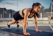 chica realizando mountain climbers o abdominales escaladores al aire libre